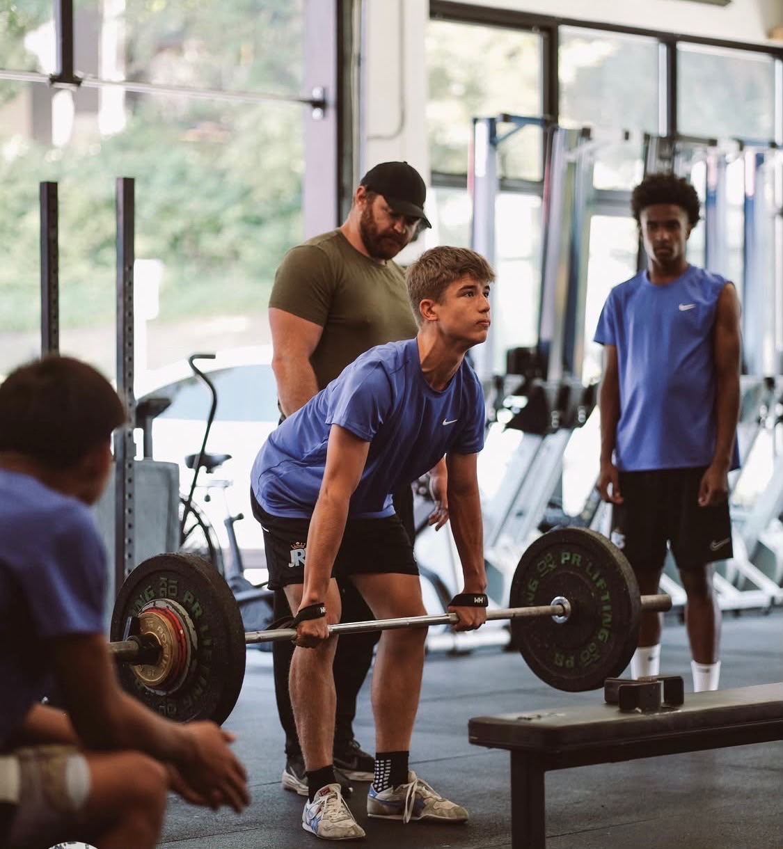 James Hellums supervising a young athlete during a strength-training session.