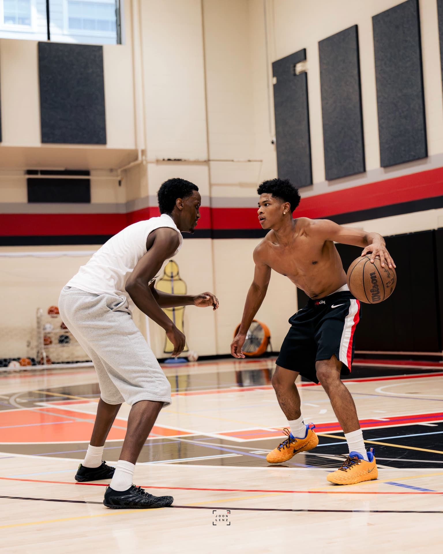 Two athletes working live one-on-one during a small-group training session.